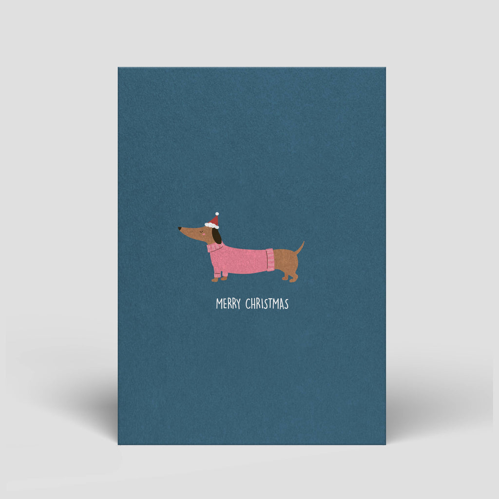 Postkarte „Merry Christmas“ – Dackel in festlicher Kleidung